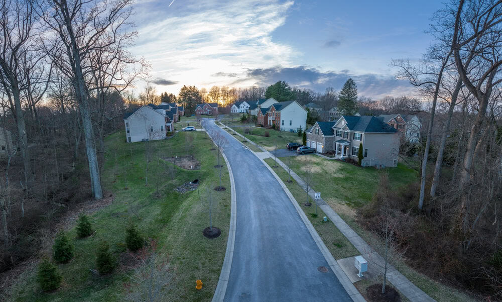 An aerial view of a suburban street lined with houses at sunset in Clarksville, Maryland.