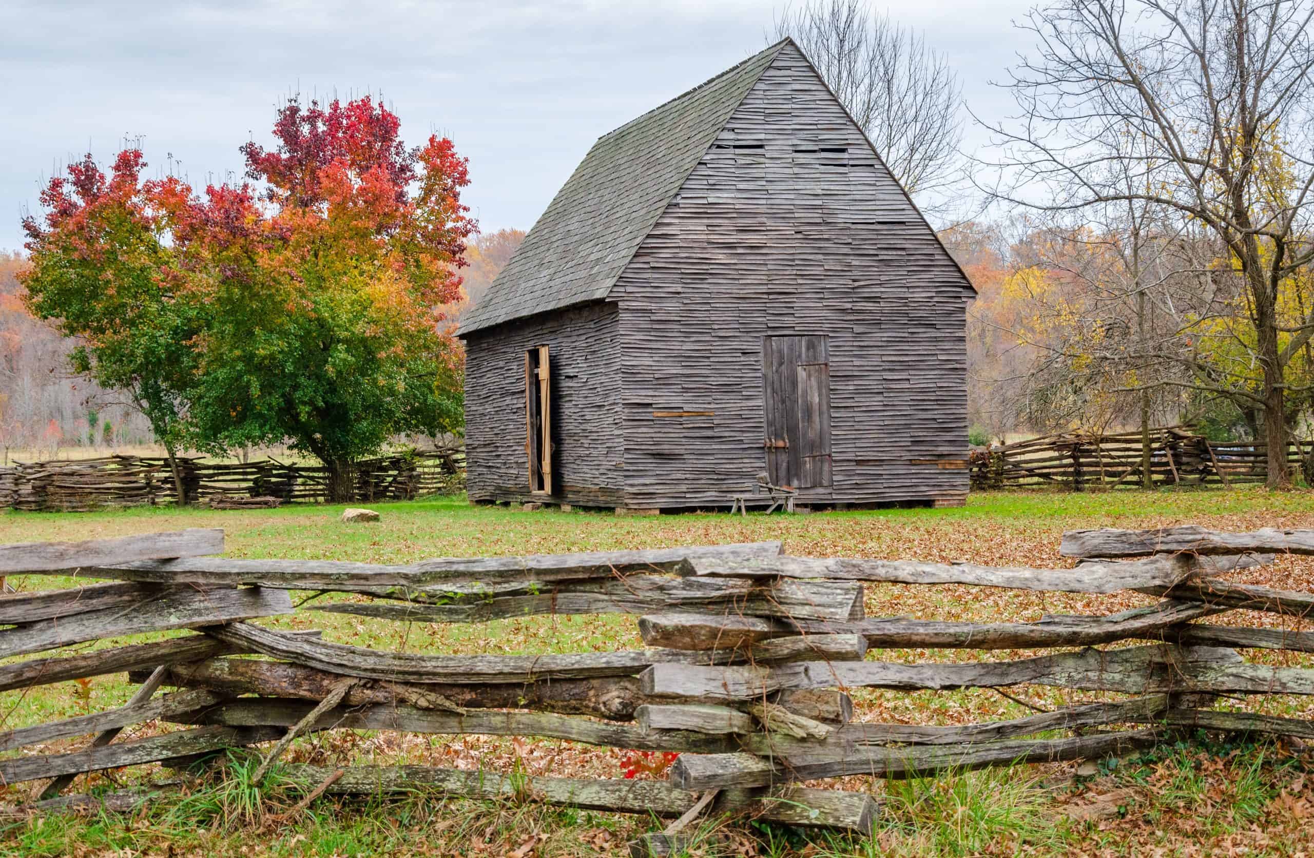 Wooden barn and split rail fence.