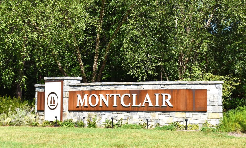 A stone entrance sign for the Montclair community, surrounded by trees, in Prince William County, Virginia