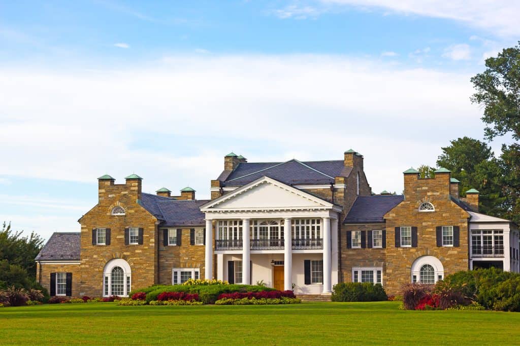 A grand brick mansion with white columns and manicured lawns in Rockville, Maryland