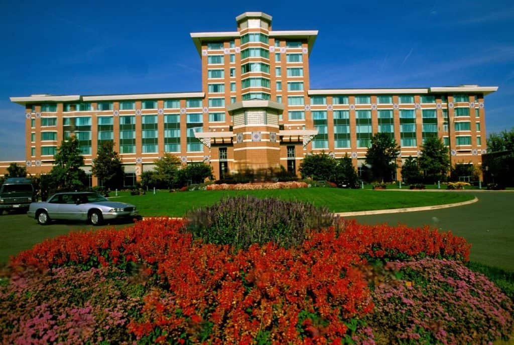 A flower bed fronts the brick and glass tower of the Lansdowne Resort in Lansdowne, Virginia