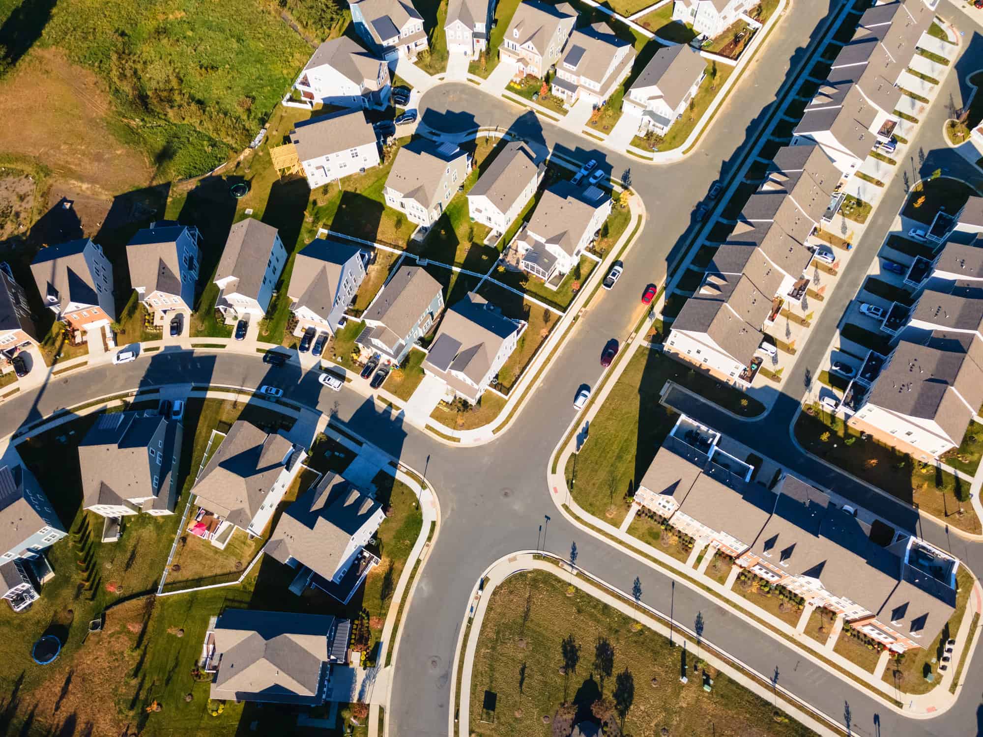 An aerial view of a suburban neighborhood with houses, driveways, and curving streets near Aldie, Virginia
