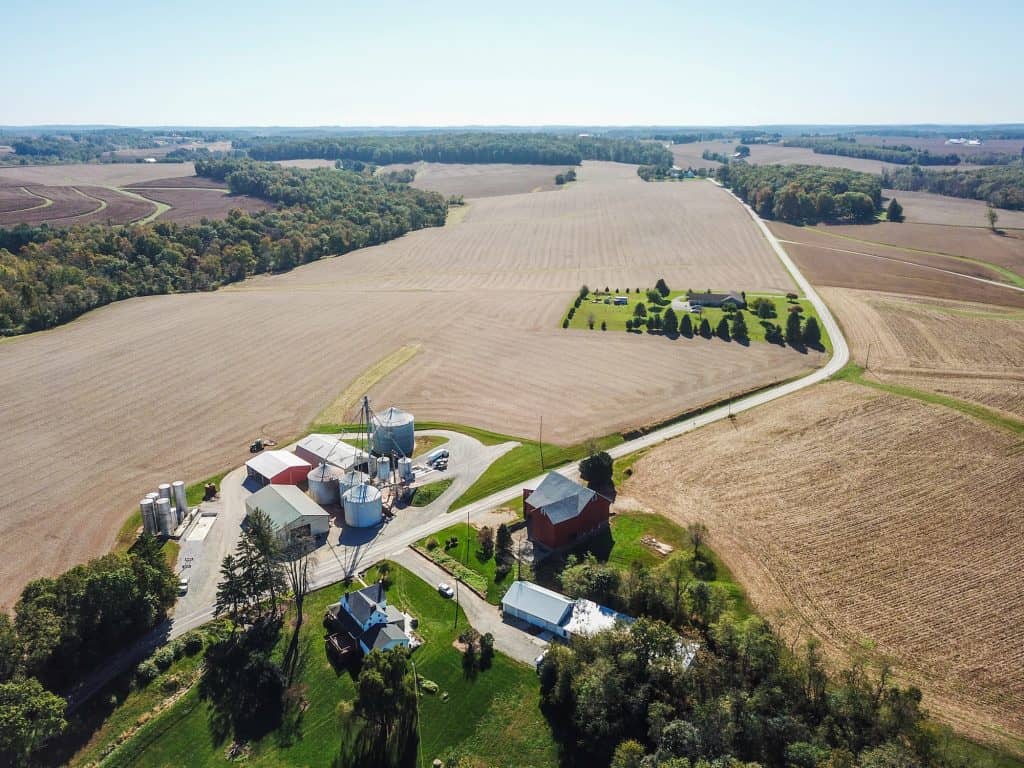 An aerial view of a farm with grain silos and barns surrounded by fields near Spring Grove, Pennsylvania