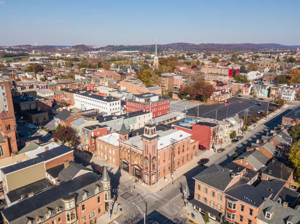 An aerial view of downtown York, Pennsylvania, with brick buildings, a church steeple, and streets