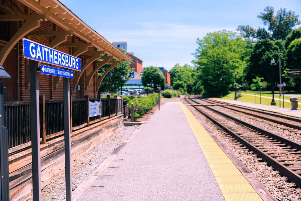 The brick Gaithersburg MARC train station platform with a blue Gaithersburg sign