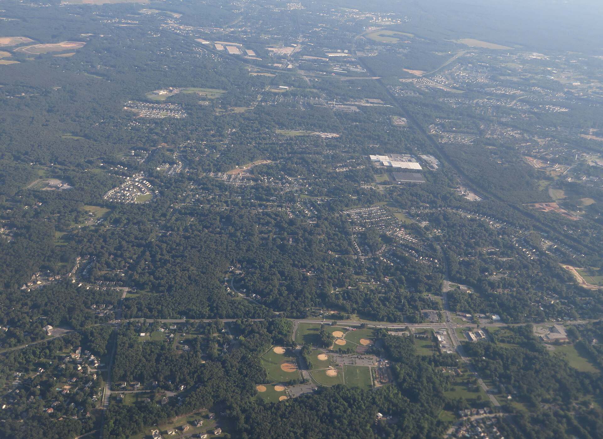 Aerial view of the wooded neighborhoods and open land around Severn, Maryland