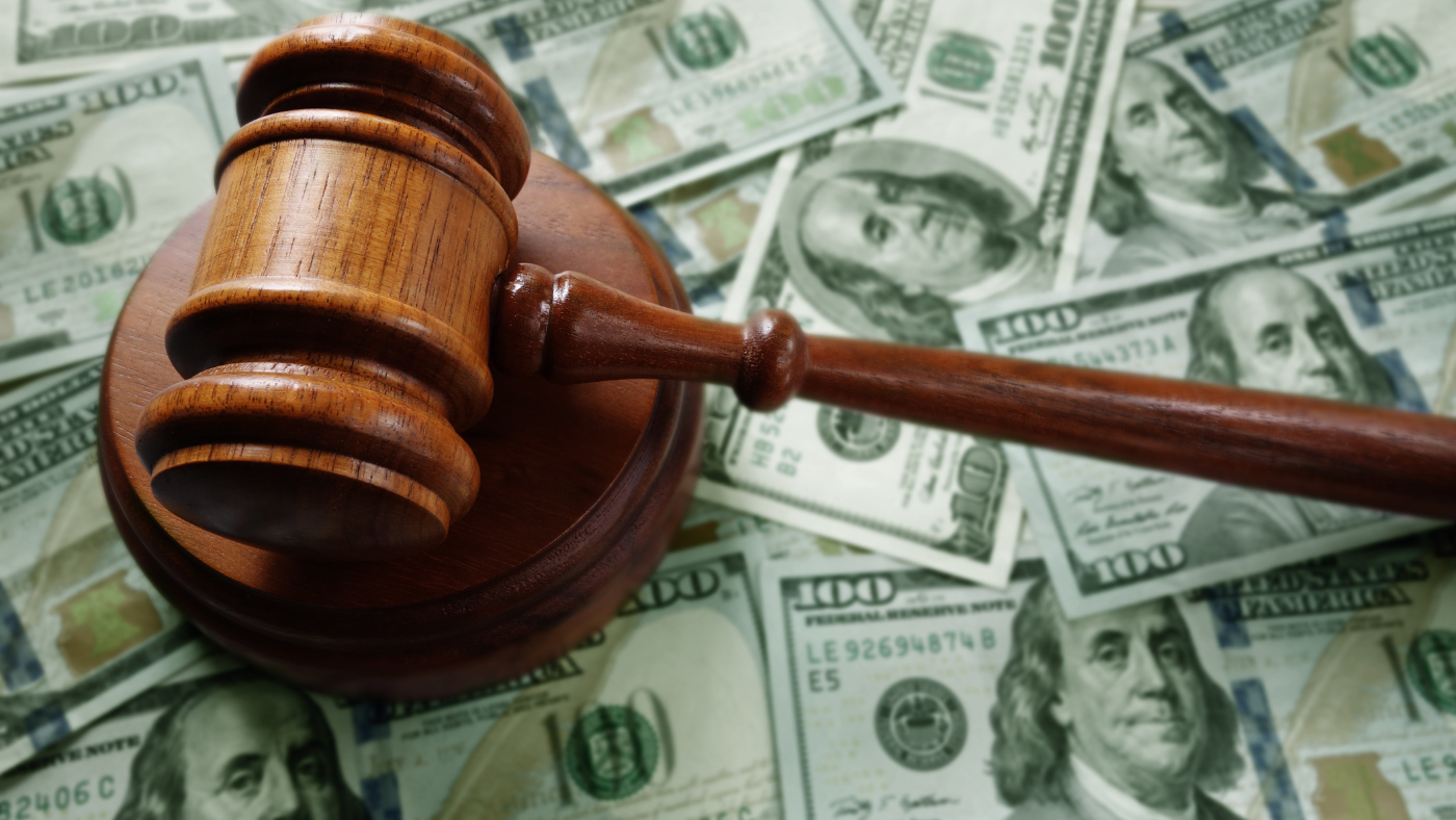An image of a gavel on top of dollars symbolizing Options to Consider for Managing Divorce Expenses