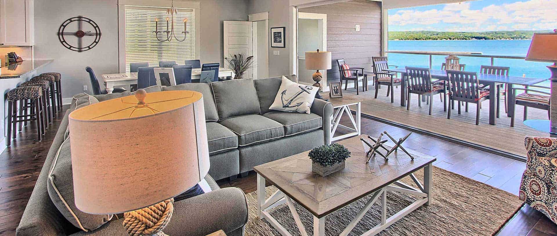 A bright, inviting living room with lakeside views, comfortable seating, and modern decor in a North.