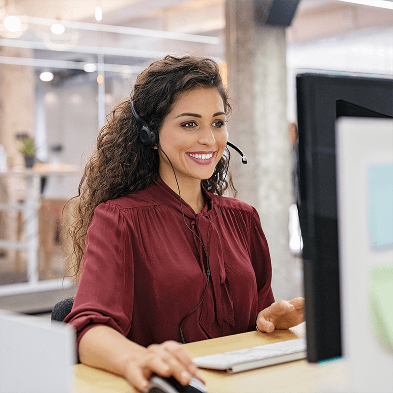 Smiling licensed health insurance agent assisting a Nebraska resident with selecting affordable coverage options