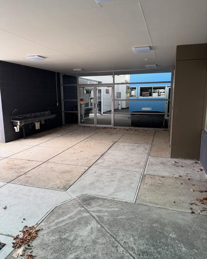 Before stencil concrete resurfacing at a Pakenham school entrance showing worn concrete ready for preparation.