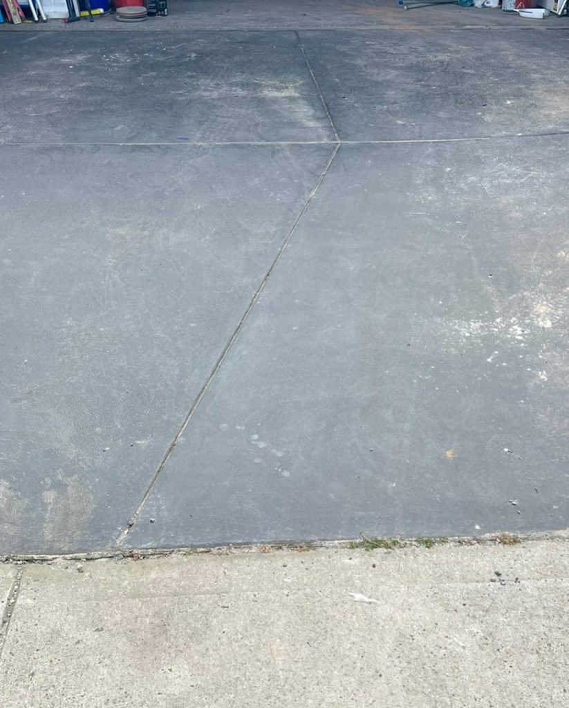 worn concrete driveway before restoration and sealing