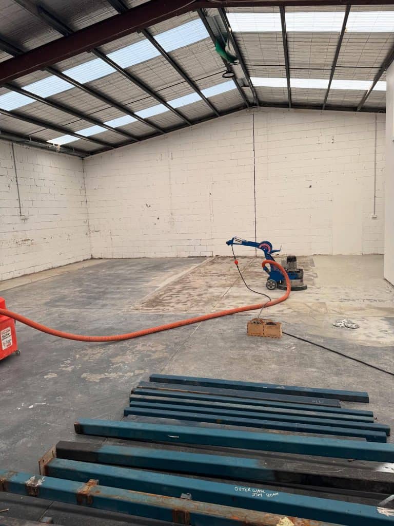 Industrial concrete grinding for epoxy floor preparation in Melbourne factory