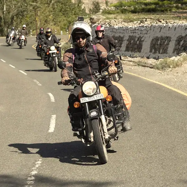 Riders on Royal Enfields in line on a Ladakh road — Ladakh motorcycle tours, Outriders Co.