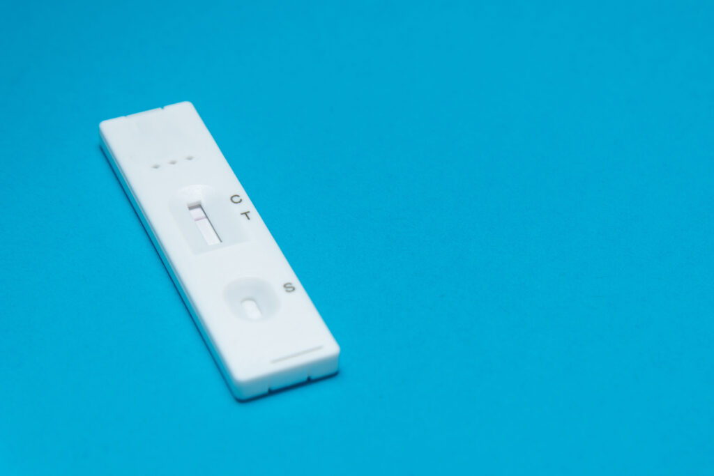 Lateral flow test cassette on a blue background