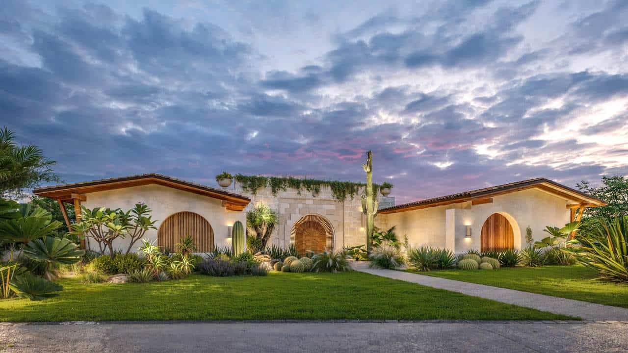 A House With A Large Lawn And Cactus
