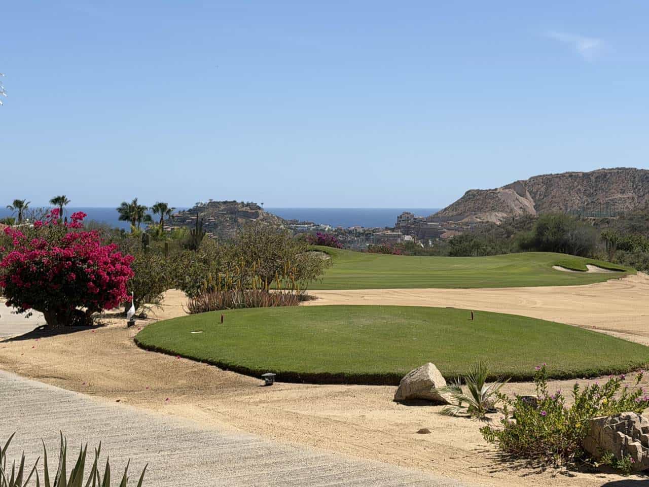 Palmilla Golf Course Featuring Lush Greens And Ocean Vistas In The Background.