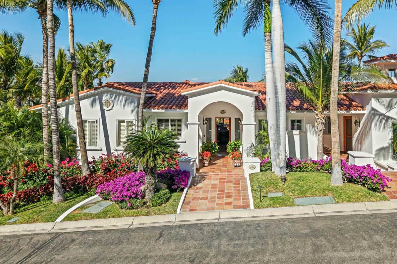 Palmilla Estate With Lush Tropical Landscaping And Vibrant Flowers.