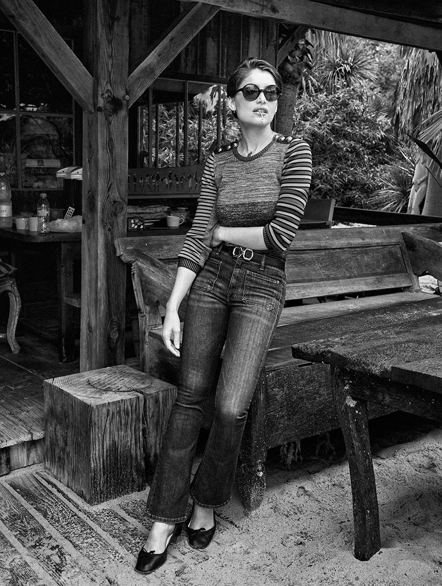 Elegant woman in vintage-inspired fashion, posing outdoors in a black and white portrait; highlights classic style and artistic photography by Pamela Hanson.