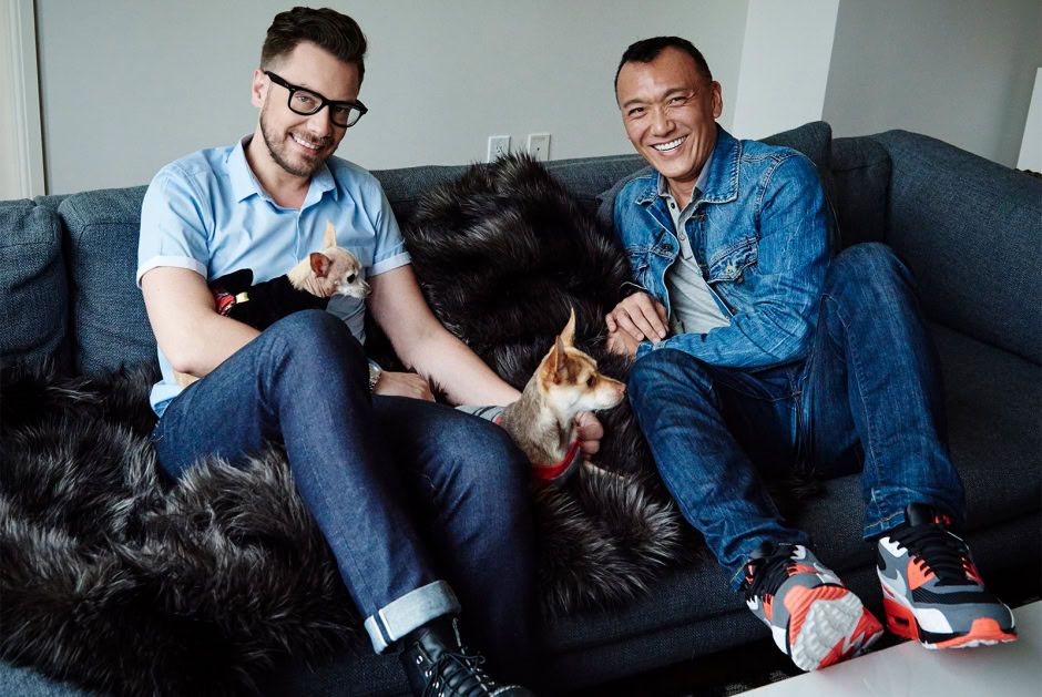 Cute diverse friends with dogs sitting on couch, portrait of friendship and pet companionship, lifestyle photography by Pamela Hanson Photography in modern home setting.