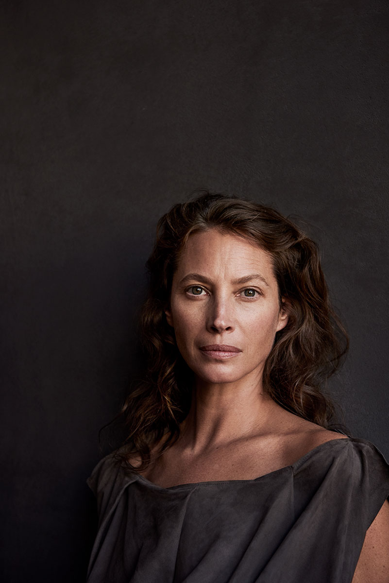 Portrait of a woman for fashion photography by Pamela Hanson, studio shot, elegant attire, natural makeup, professional model, timeless beauty, high resolution, fine art portrait, dark background, professional photography.