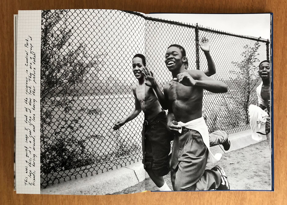 Kids playing near a chain-link fence, capturing candid joyful moments outdoors.