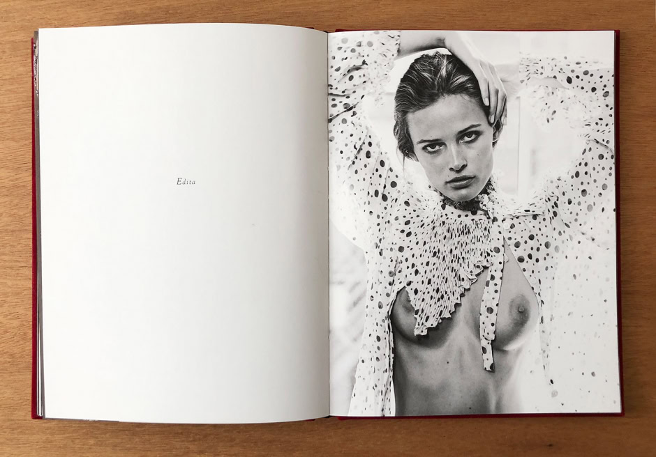 Elegant black and white portrait of a woman with intense gaze, wearing a polka dot blouse with ruffled collar, showcasing high fashion photography by Pamela Hanson.
