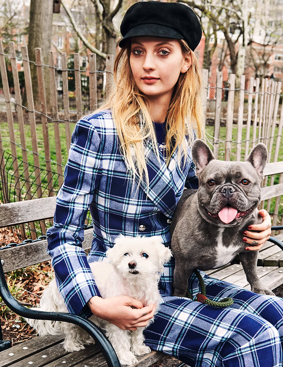 Elegant young woman in stylish blue plaid outfit with French bulldog and white fluffy dog, outdoor park setting, fashion photography, lifestyle portrait, professional dog photography.