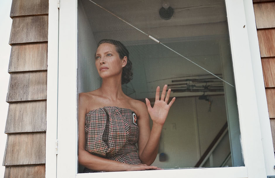 Elegant woman looking out of a window, portrait of fashion and beauty, professional photography by Pamela Hanson.
