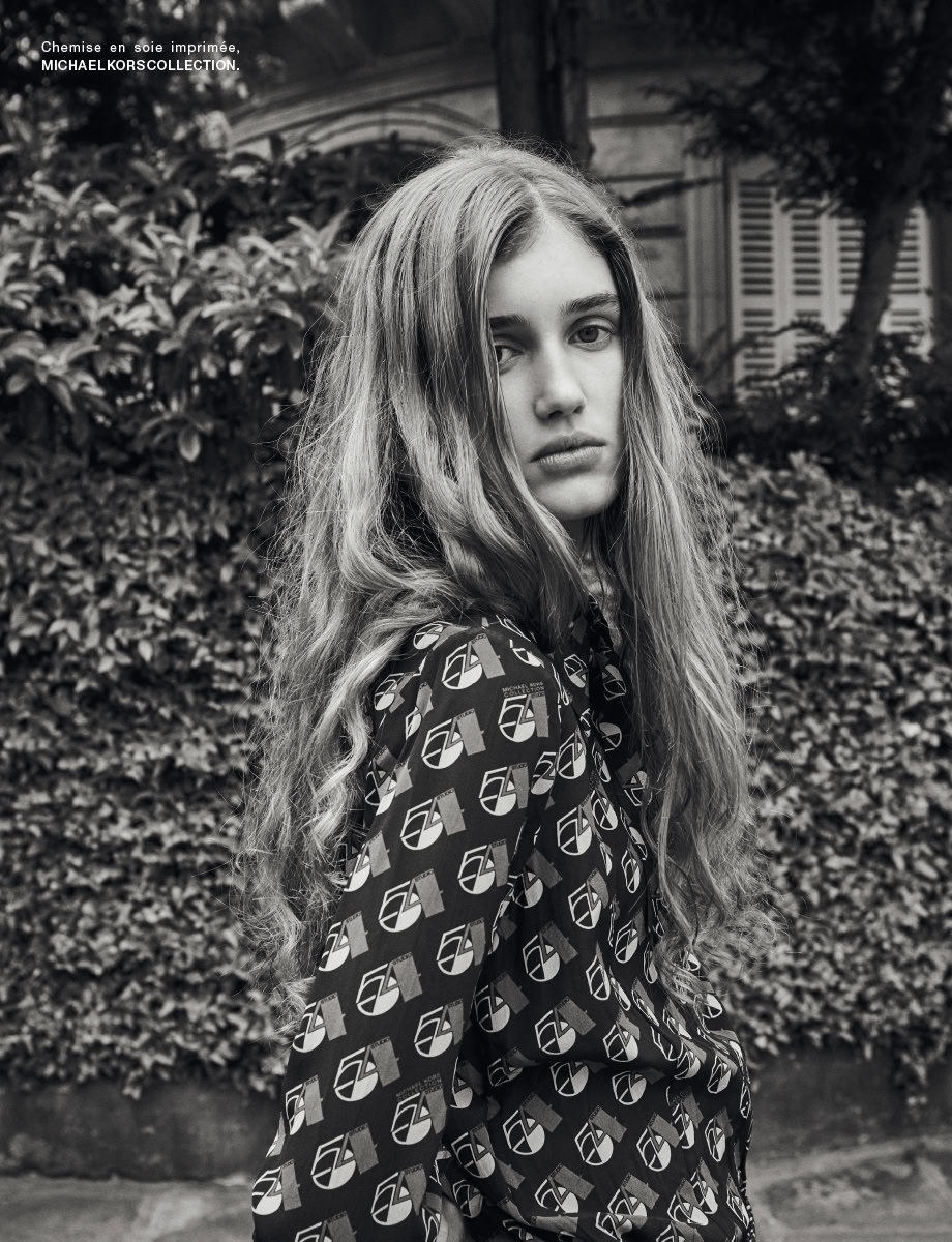 Elegant black-and-white portrait of a young woman with long wavy hair, wearing a patterned silk shirt, showcasing high fashion photography by Pamela Hanson.