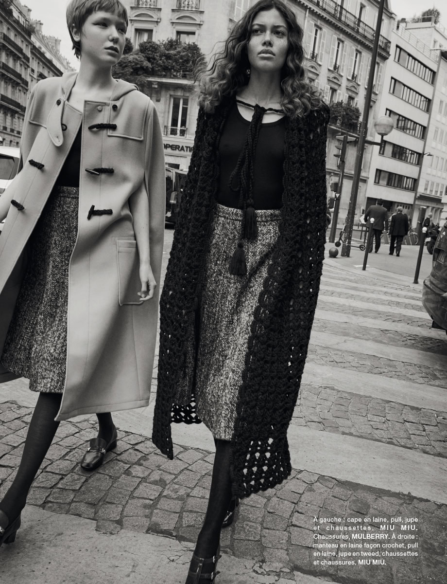 Elegant black and white street fashion photography showcasing women in high-end designer clothing in an urban Paris setting, highlighting sophisticated women's fashion.