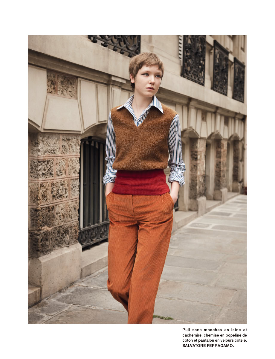 Vintage street fashion photography featuring a young woman in stylish layered clothing.