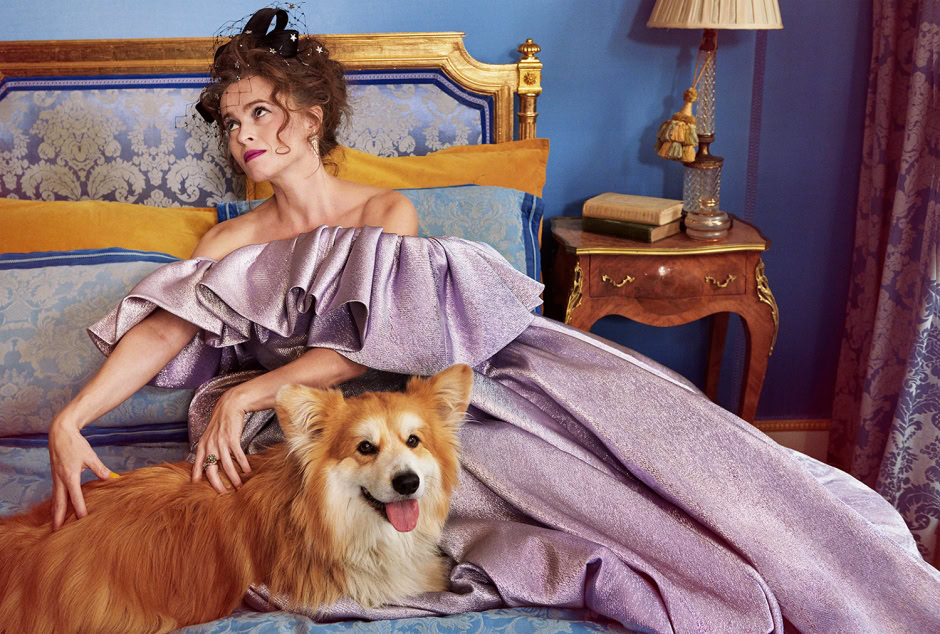 Elegant woman in vintage-inspired gown lying on luxurious bed with a friendly, fluffy dog, surrounded by classic decor and ornate furniture, capturing timeless fashion photography.