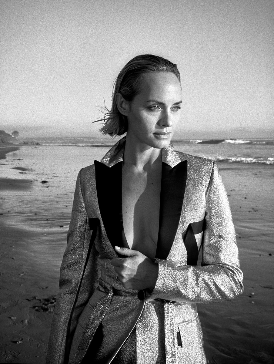 Elegant female model in a metallic blazer on a beach, black-and-white portrait emphasizing fashion photography quality, captured by Pamela Hanson.