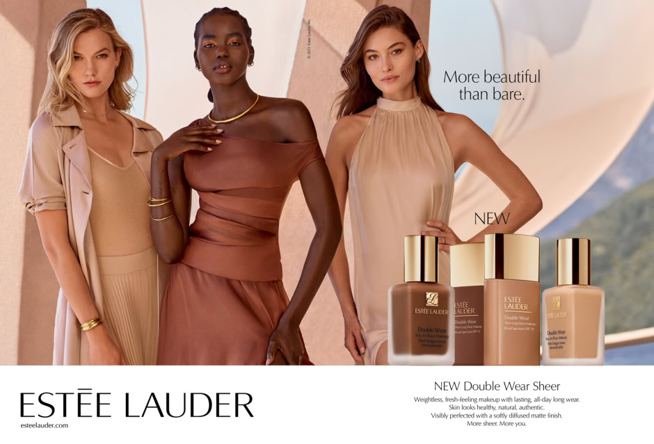 Elegant diverse models wearing neutral-toned fashion and Estée Lauder Double Wear foundation bottles in a sophisticated outdoor setting.