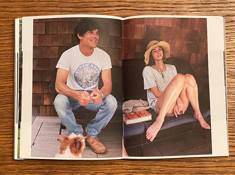 Casual outdoor portrait of a man and woman relaxing on a wooden deck with a dog, showcasing lifestyle photography by Pamela Hanson.