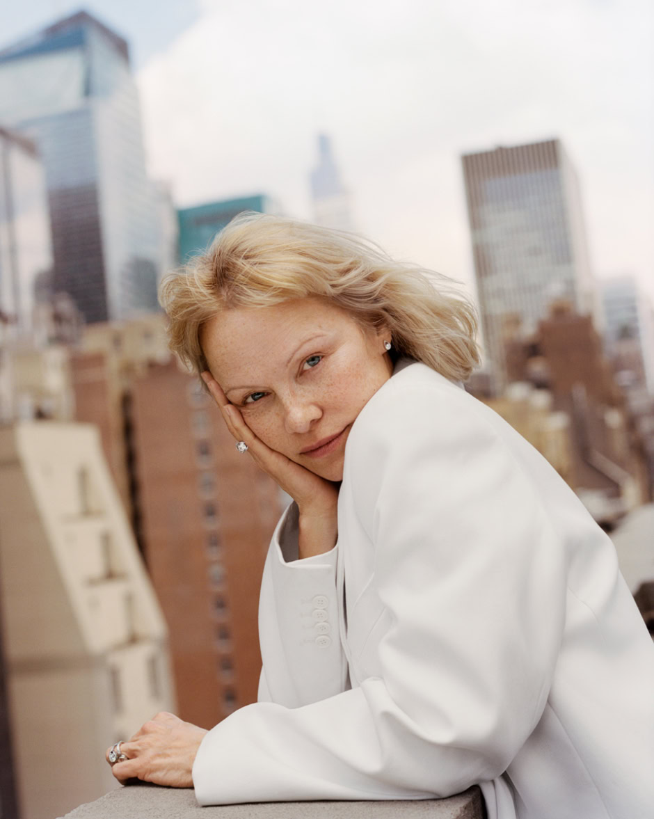 Elegant woman portrait on a city rooftop, showcasing modern fashion and urban scenery, captured by Pamela Hanson Photography for contemporary lifestyle and portrait photography.