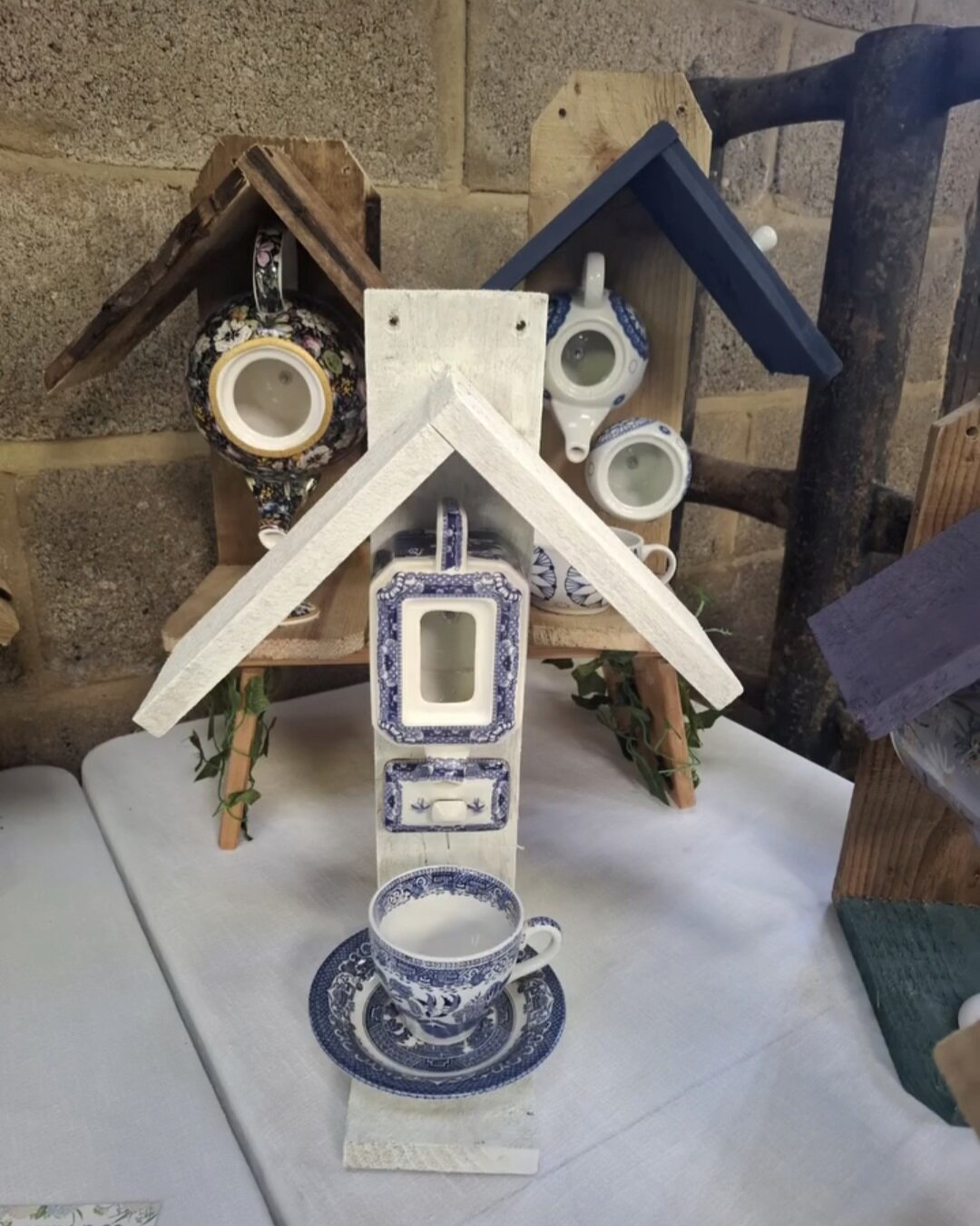 Upcycled bird feeders made from reclaimed materials, showcasing eco-friendly craftsmanship.