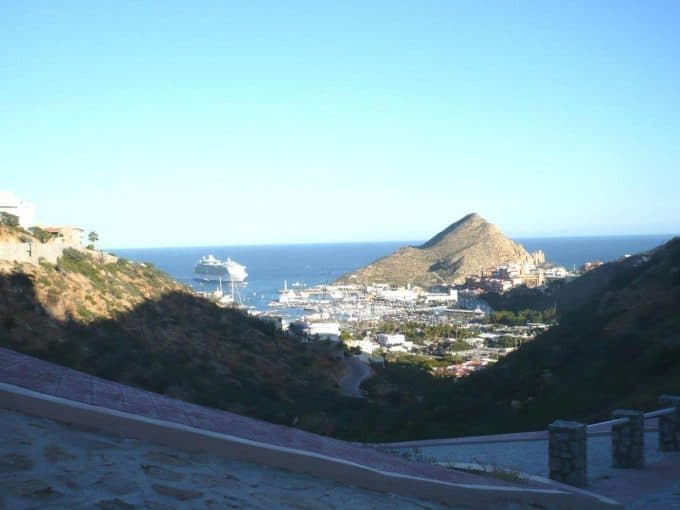 Alt Text: Breathtaking View Of Pedregal Featuring A Marina With Yachts, Surrounding Hills, And A Prominent Mountain Against A Clear Blue Ocean And Sky.