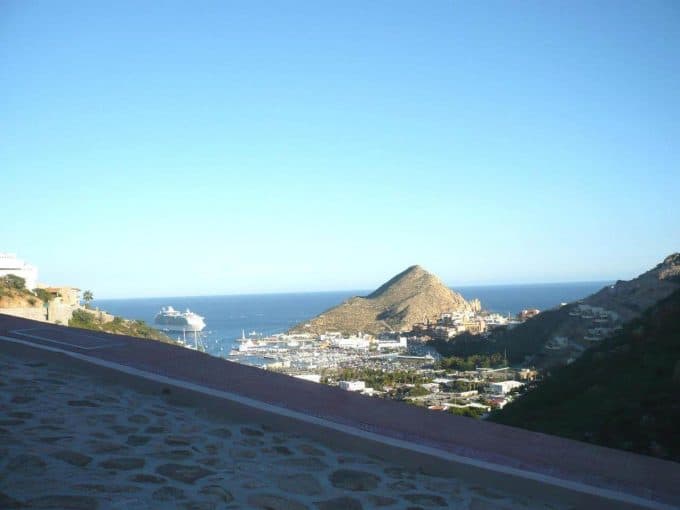 Stunning View Of Pedregal'S Coastal Marina With Mountains And Boats In The Background, Showcasing Luxury Living And Breathtaking Scenery.