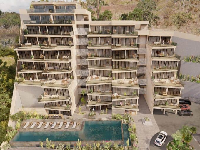 Contemporary Pedregal Luxury Condo Building With Spacious Balconies, Outdoor Pool, And Scenic Hillside Views At Pedregal Real Estate In Mexico City.