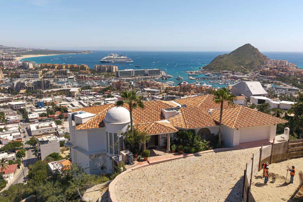 Luxurious Pedregal Ocean View Home With Terracotta Roof Tiles Overlooking The Puerto Vallarta Marina And Mountain Landscape, Featuring Pristine Architecture And Breathtaking Waterfront Scenery.