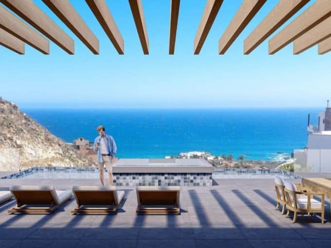 Breathtaking View Of The Ocean From A Luxurious Pedregal Estate Terrace With Modern Outdoor Furniture And A Clear Blue Sky.