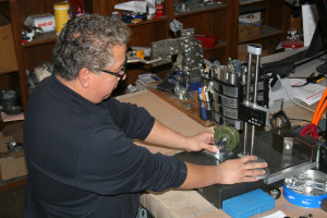 Man working on caster wheel assembly at P&H Casters workshop.