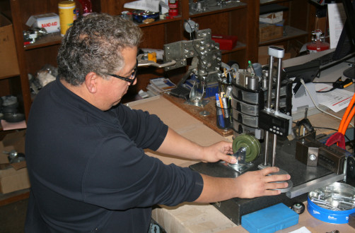 Man working on caster wheel assembly at P&H Casters workshop.