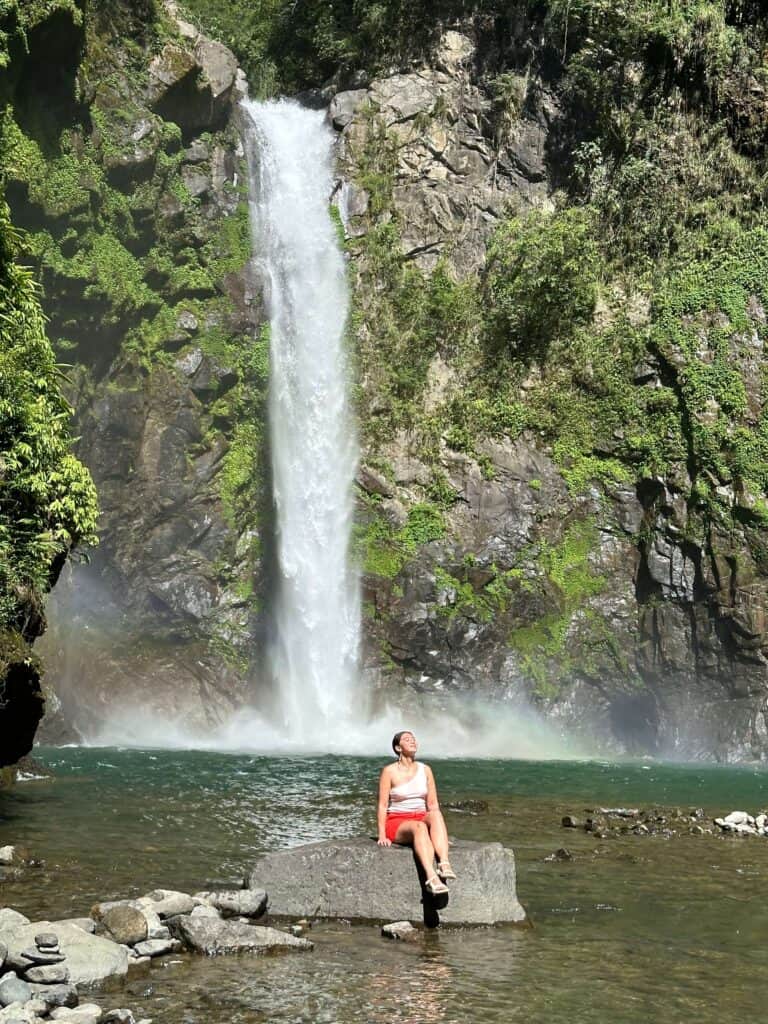 A quiet moment by the falls after a challenging trek