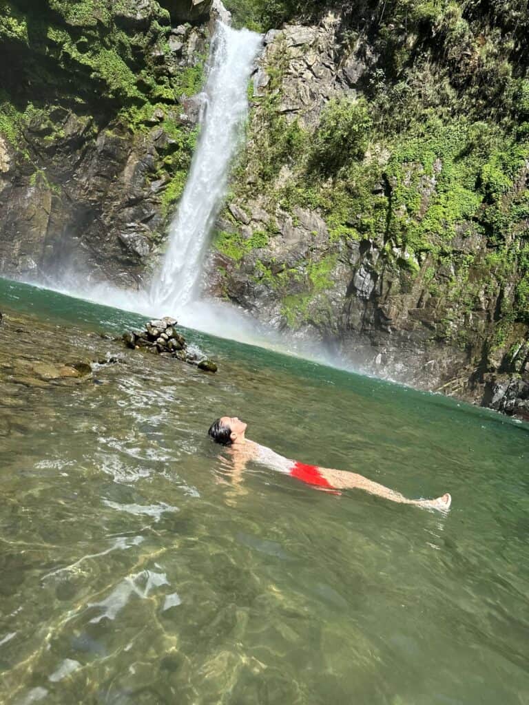 Taking a dip in the cool waters beneath the cascade