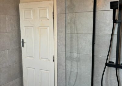 Modern bathroom with shower and tile walls