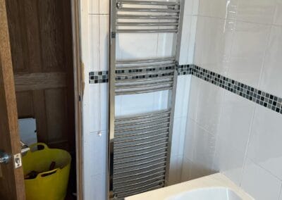 Modern bathroom with chrome towel radiator.