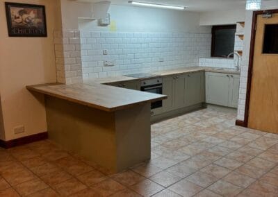 Modern kitchen with wooden counters and tiled floor.