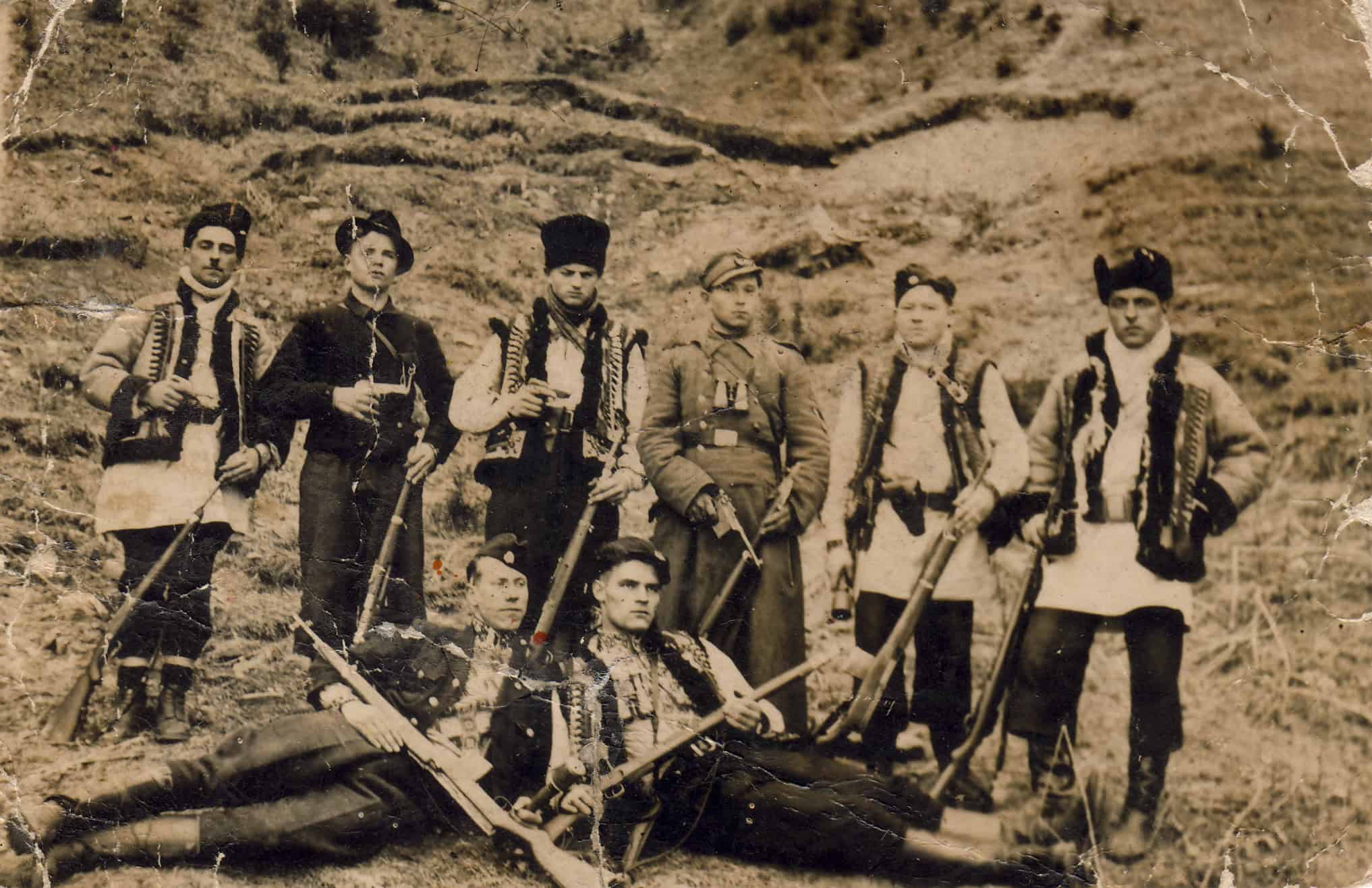 Група повстанців УПА з зброєю на природі, історична фотографія.